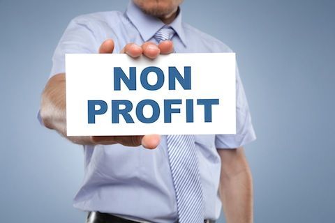 Man holding a sign that says, non profit
