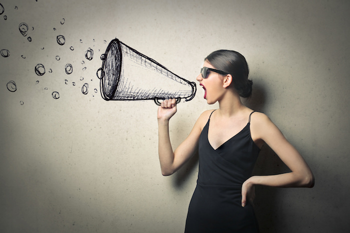 Blog header image showing a woman shouting through an animated loudspeaker. 