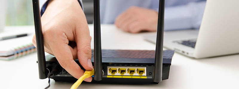 Image of ethernet cord being plugged into router.