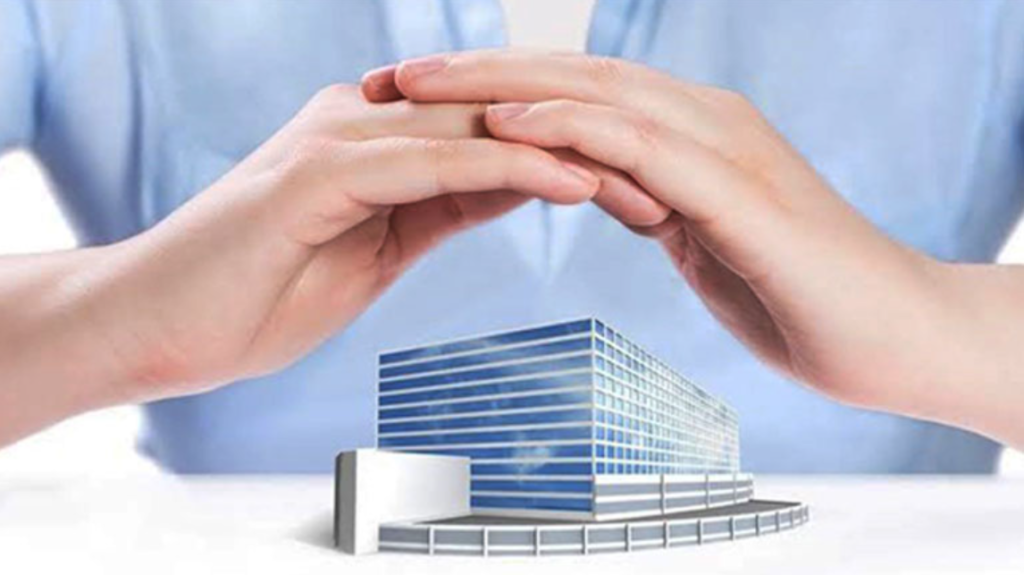 Image of person cusping hands over a model building.