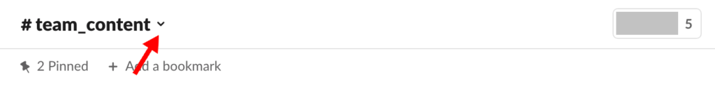 Slack channel header with red arrow pointing to drop down arrow next to channel name