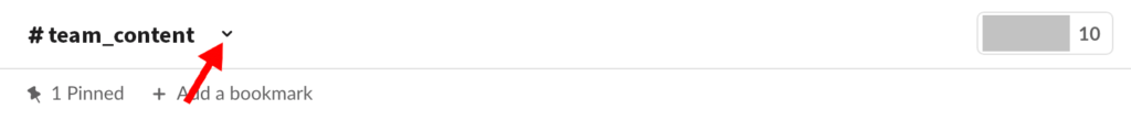 Slack channel header with red arrow pointing to drop down arrow next to channel name