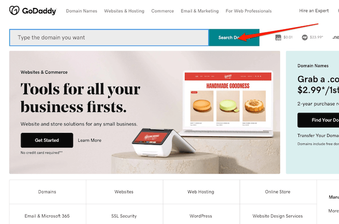 GoDaddy homepage with red arrow pointing to search bar