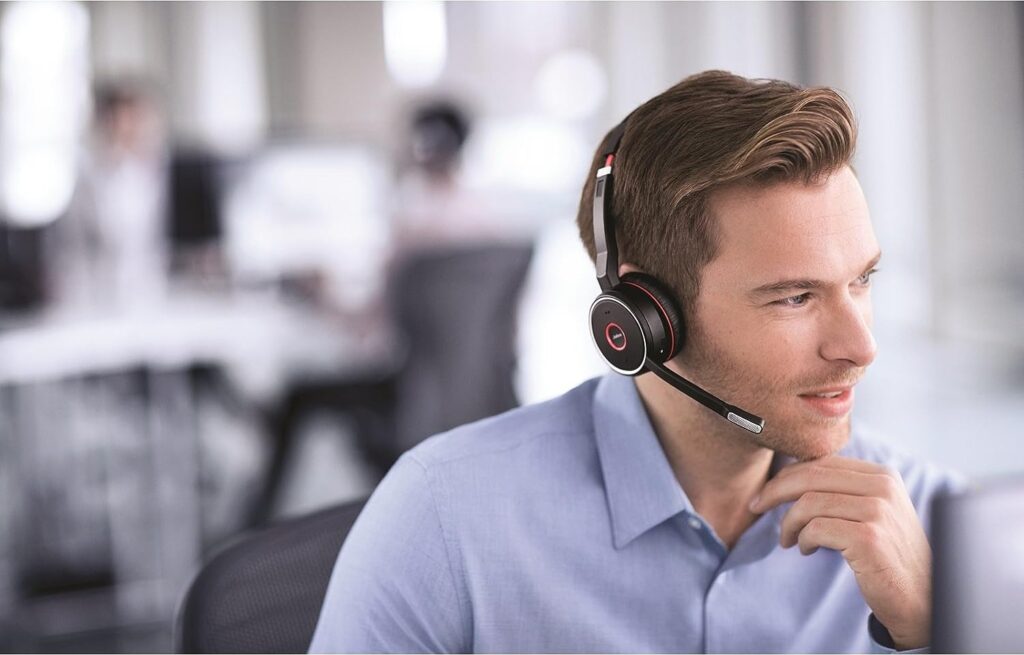 Person with headset on in office setting. 