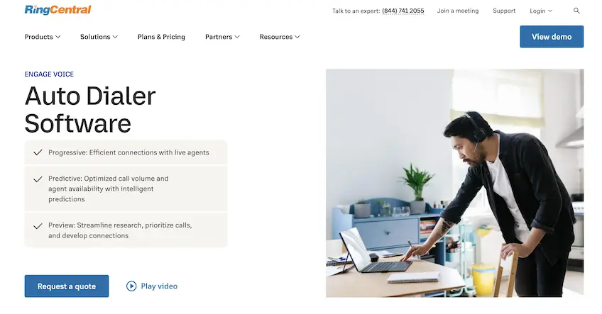 Screenshot of RingCentral's Auto Dialer Software landing page, showing a man wearing a headset, standing while using a laptop on a desk