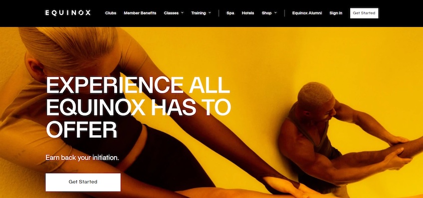 Equinox homepage with an image of two people stretching. 